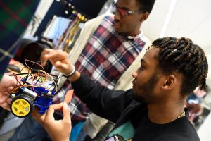Two Johns Hopkins undergraduates work on a robot