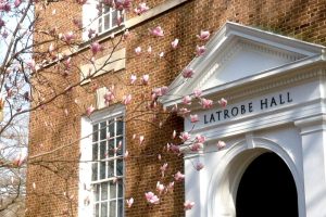 A view of the Latrobe Hall building and the cherry blossoms on the side.