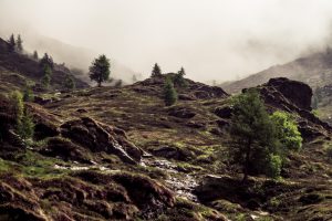 A rocky mountain with dusty fog in the background.
