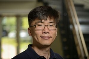 A headshot of Taekjip (T.J.) Ha wearing a black shirt.
