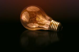 A yellow bulb on a black surface.