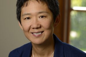 A headshot of Rong Li wearing an indigo blazer over a white top.