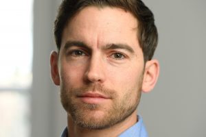 A headshot of Carsten Prasse wearing a blue shirt.
