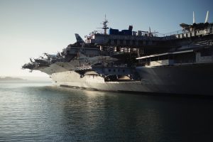A navy ship equipped with aircrafts in the sea.
