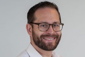A headshot of Richard Boyer wearing glasses