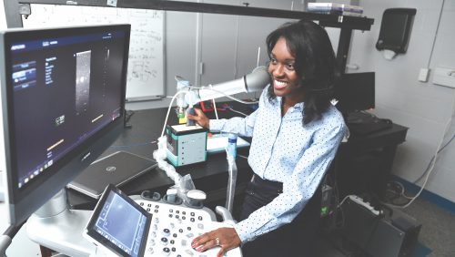 John C. Malone assistant Professor Muyinatu (Bisi) Bell, works with an imaging device in her lab.
