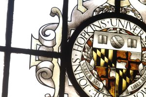 A stained glass painting of Johns Hopkins University logo