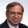 A headshot of Krishan Sabnani in a black suit and a tie.