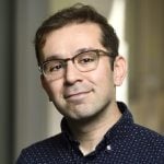 A headshot of Daniel Khashabi wearing a dark blue shirt