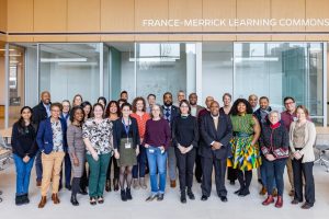 Attendees of the Structural Racism Convening pose for a photo outside the France-Merrick Learning Commons.