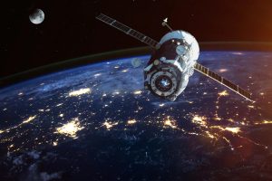 A rendering of a satellite in space above the Earth.