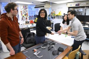 JHU engineering students work together in the lab on their design project to help a local artist. 
