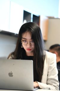 Yutong Bai sits at a laptop computer