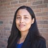 Shilva Shrestha pictured in a headshot in front of a brick wall.