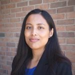 Shilva Shrestha pictured in a headshot in front of a brick wall.
