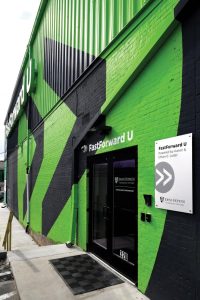 The exterior wall of Fast Foward U: a green and black design. 