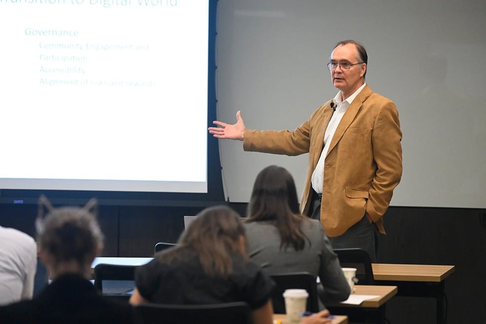Jim Bellingham presents to attendees, gesturing towards a screen.