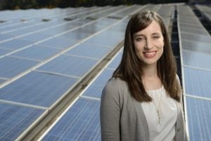Headshot photo of Susanna Thon in front of solar panels.