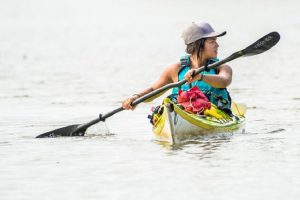 A photo of Maya Dizack rowing a kayak