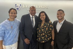 Doctoral students taking a photo Dr.Percy Pierre.