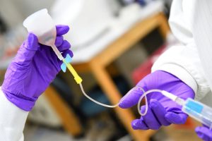 Students extract blood from a prototype menstrual cup. 