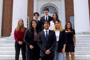 8 members of the PeriAlert team pose for a group photo in front of Gilman Hall