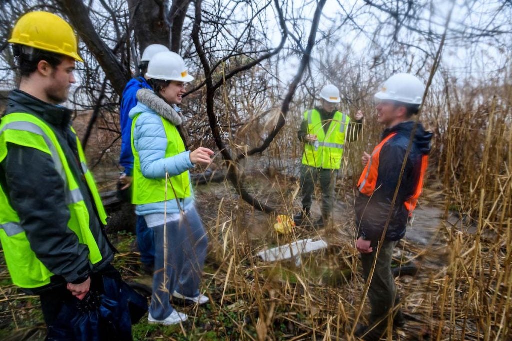 Students and treatment plan staff explore the wetlands next to the plant. 
