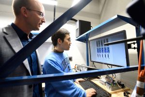Professor Gernay and a student review fire simulation data on a computer screen in a research lab.