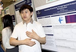 Young man presenting his poster about seeing sound at Design Day