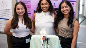 Team members Kelly Tamura, Riya Gupta, and Roshin Varghese with GaitPro device