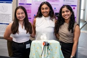 Team members Kelly Tamura, Riya Gupta, and Roshin Varghese with GaitPro device