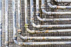 A closeup of old pipes on a wall