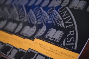 Image of 2025 Doctoral Hooding Ceremony programs. 