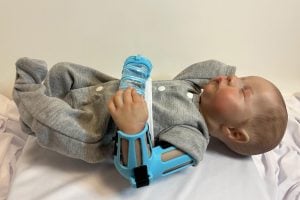 A photo of the baby doll wearing the DINA