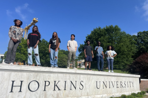 PROPEL students standing on Hopkins wall posing