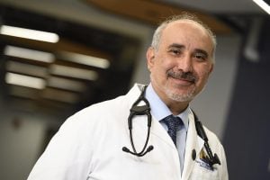 Peter Abadir in a medical coat with stethoscope 