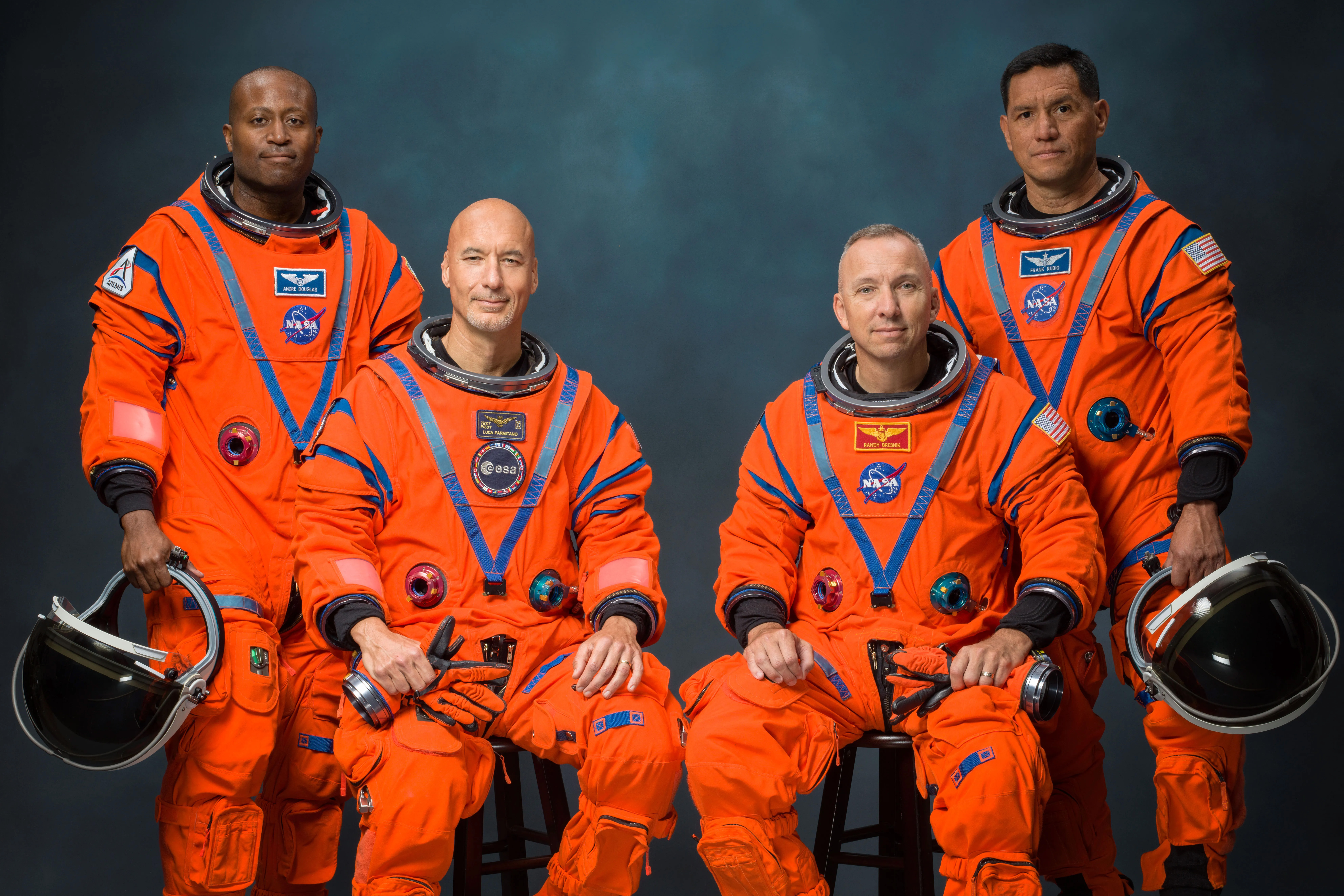 group picture of Artemis III crew in orange space suits